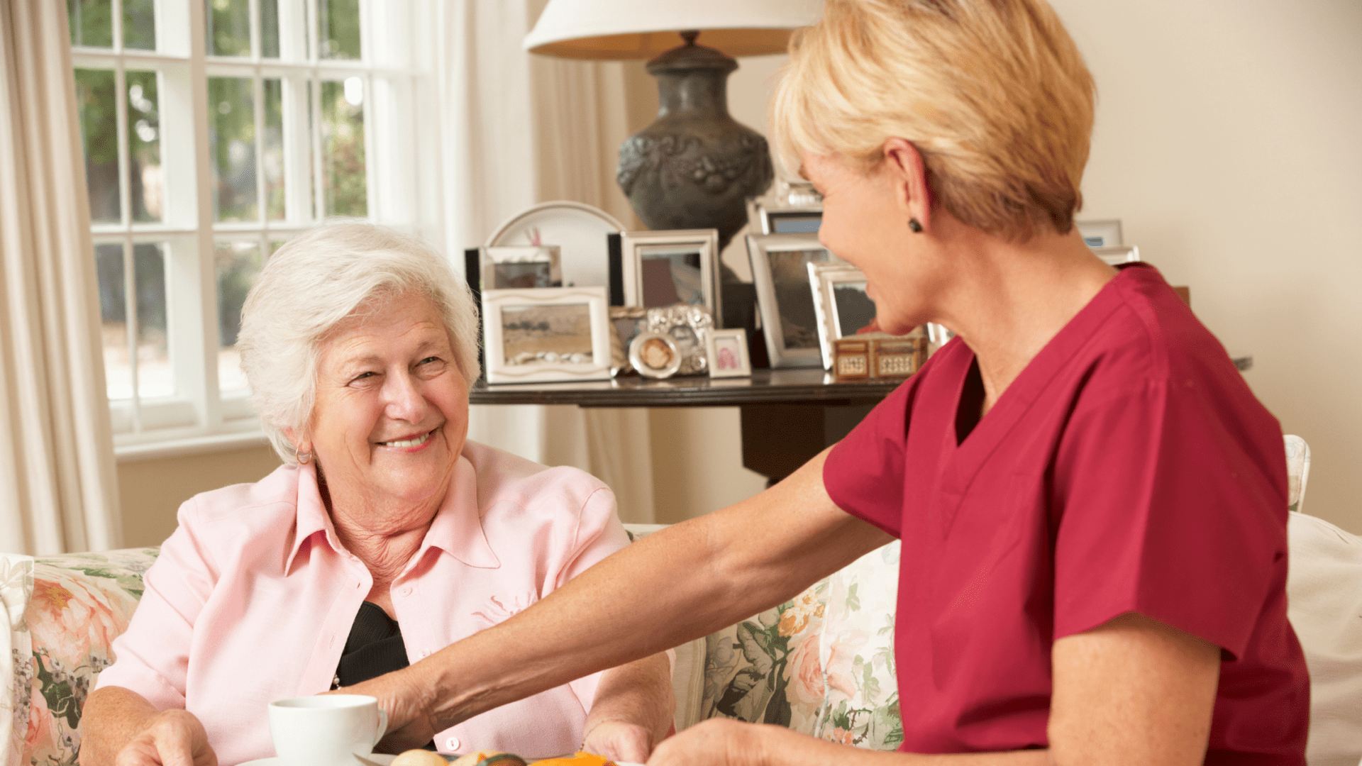 women smiling at an older woman