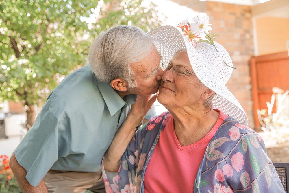 Older couple - man kissing woman's cheek