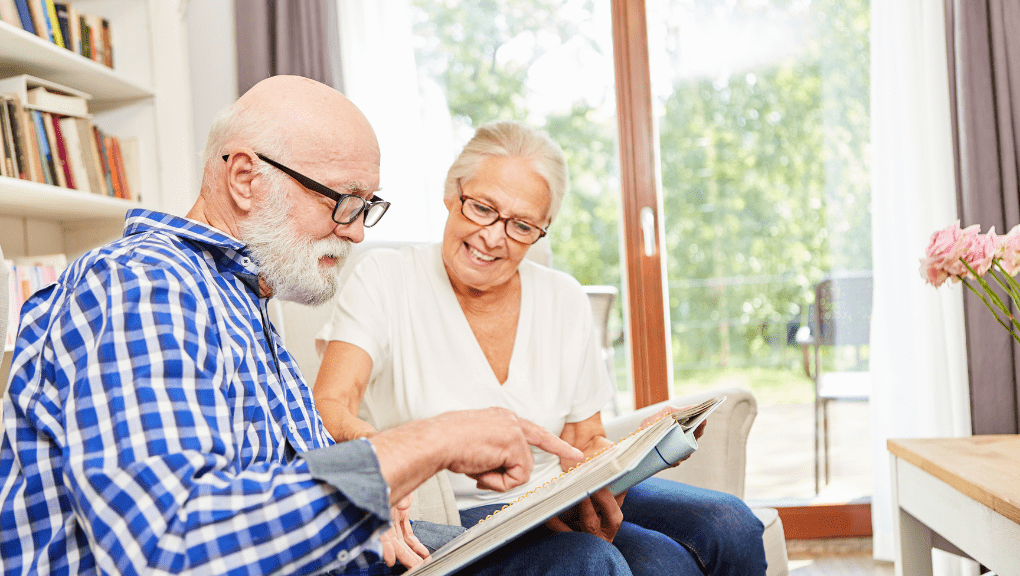 elderly looking at a photo album transition to assisted living