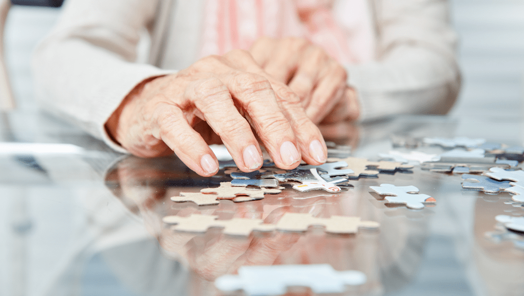 Senior doing a puzzle at a memory care facility