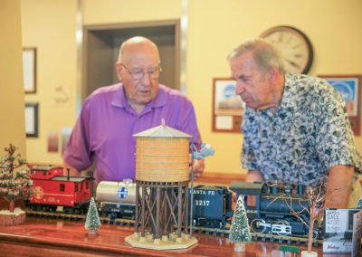 two men by a model train
